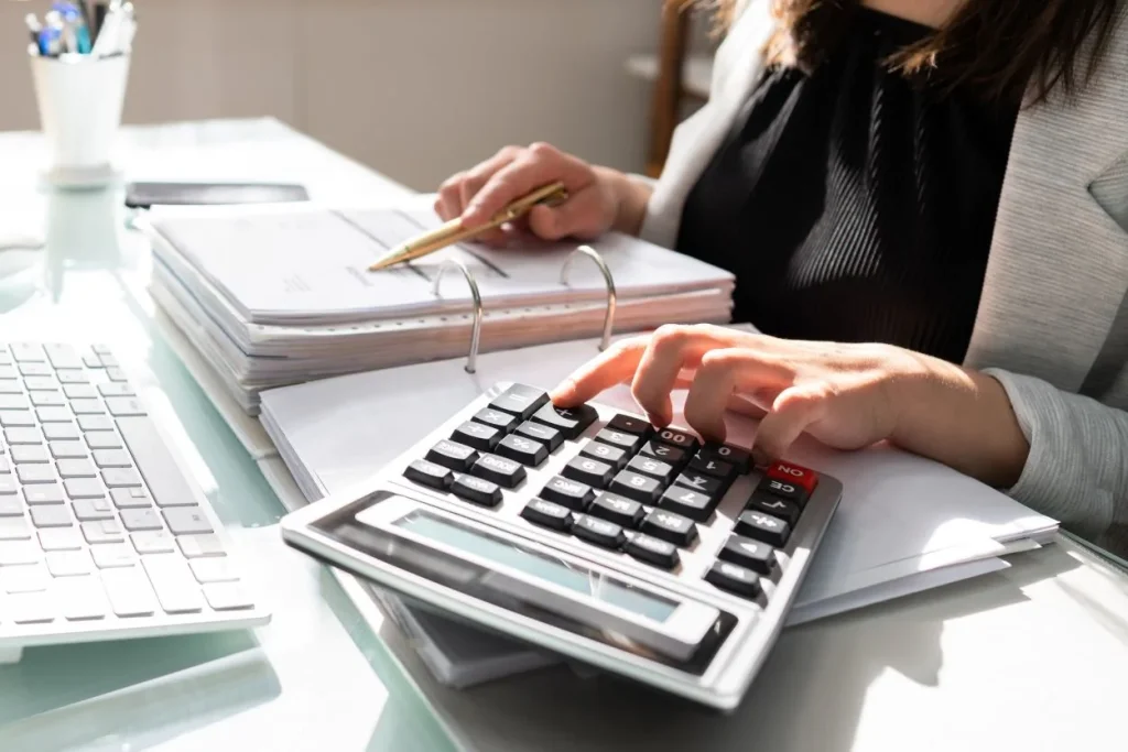 photo of an Edmonton bookkeeper calculating and filing taxes for a small business owner in Edmonton