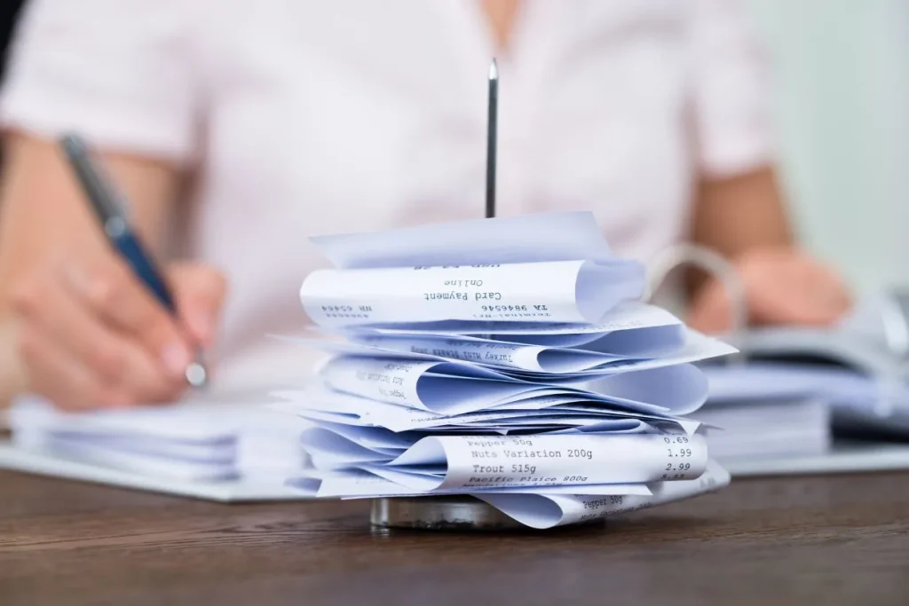 photo of receipts from expenses, being entered by a bookkeeper for small business bookkeeping